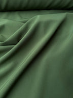 Tessuto crepe elastico verde safari per capi aderenti