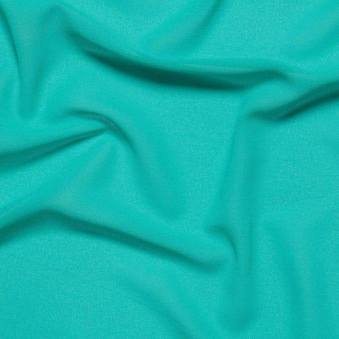 Tessuto georgette tinta unita turchese, leggero e trasparente, perfetto per abiti eleganti e camicie
