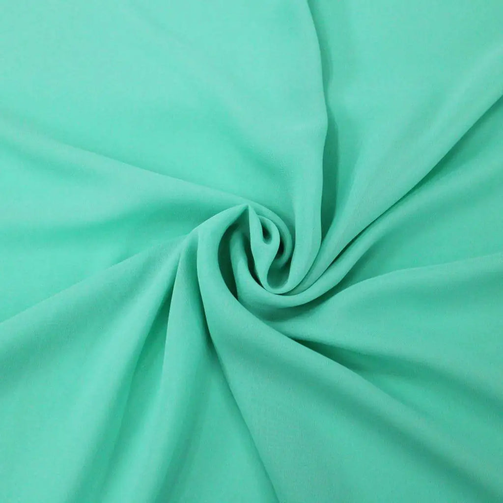Tessuto georgette tinta unita verde-tiffany, leggero e trasparente, perfetto per abiti eleganti e camicie
