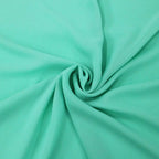 Tessuto georgette tinta unita verde-tiffany, leggero e trasparente, perfetto per abiti eleganti e camicie