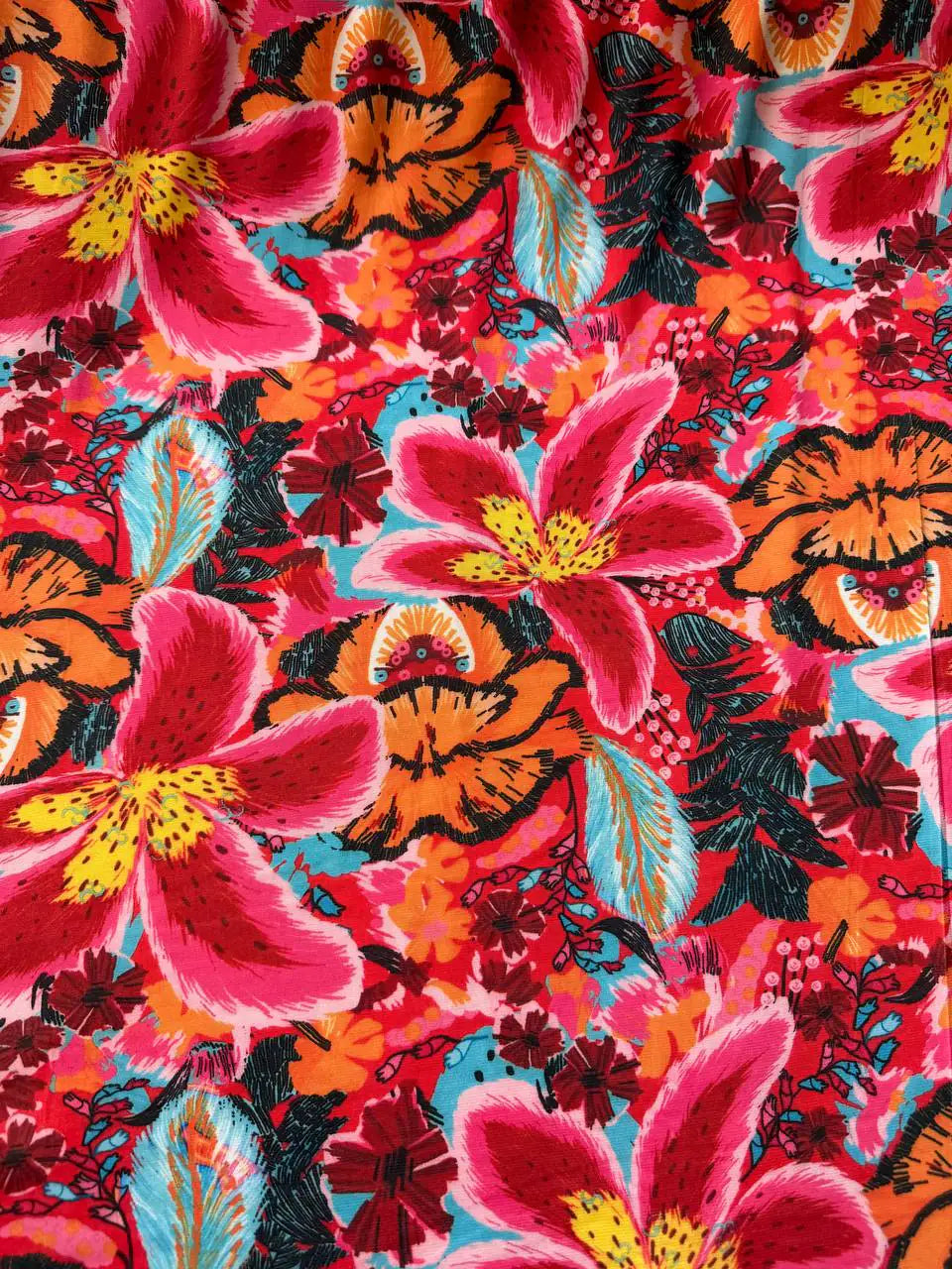 Tessuto jersey floreale esotico colore fondo arancio, morbido ed elasticizzato, ideale per abiti e maglie leggere
