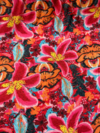 Tessuto jersey floreale esotico colore fondo arancio, morbido ed elasticizzato, ideale per abiti e maglie leggere