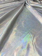 Dettaglio tessuto lycra spalmata bielastica color aurora boreale con finitura lucida effetto metallizzato