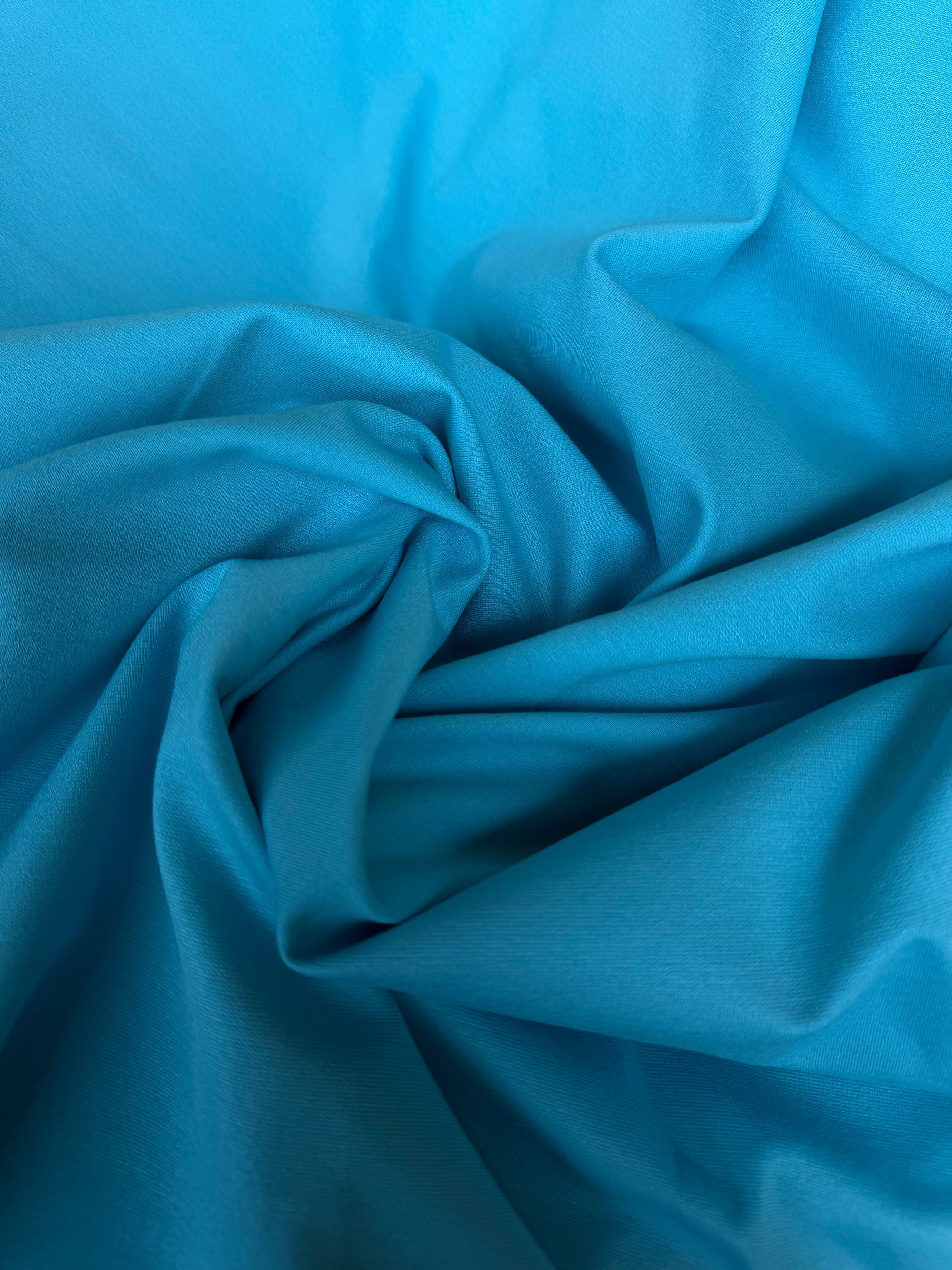 Tessuto Punto Milano celeste, jersey strutturato elasticizzato perfetto per abbigliamento elegante e sportivo